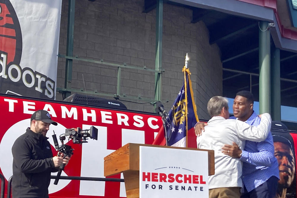 Georgia Gov. Brian Kemp campaigns alongside Senate candidate Herschel Walker on Saturday, Nov. 19, 2022 in Smyrna, Ga.