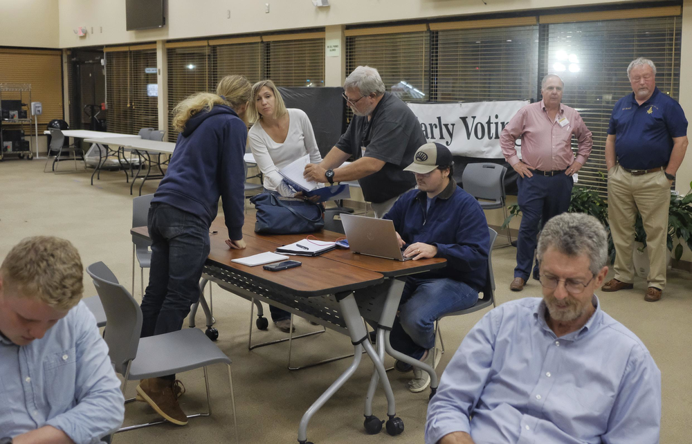 Republican poll watchers scrutinize the first batch of returns at the Bibb County Board of Elections Tuesday night.