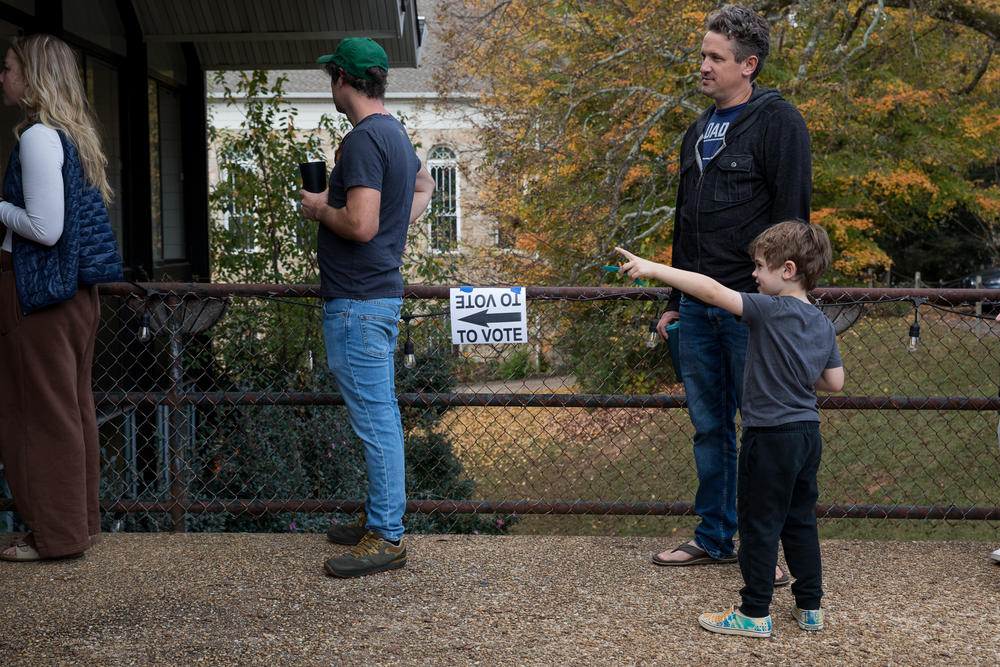 Georgia voters wait in line outside of a Fulton County polling location at 8:30 a.m. on Nov. 8, Election Day, ahead of casting their ballots in the crucial midterm election.