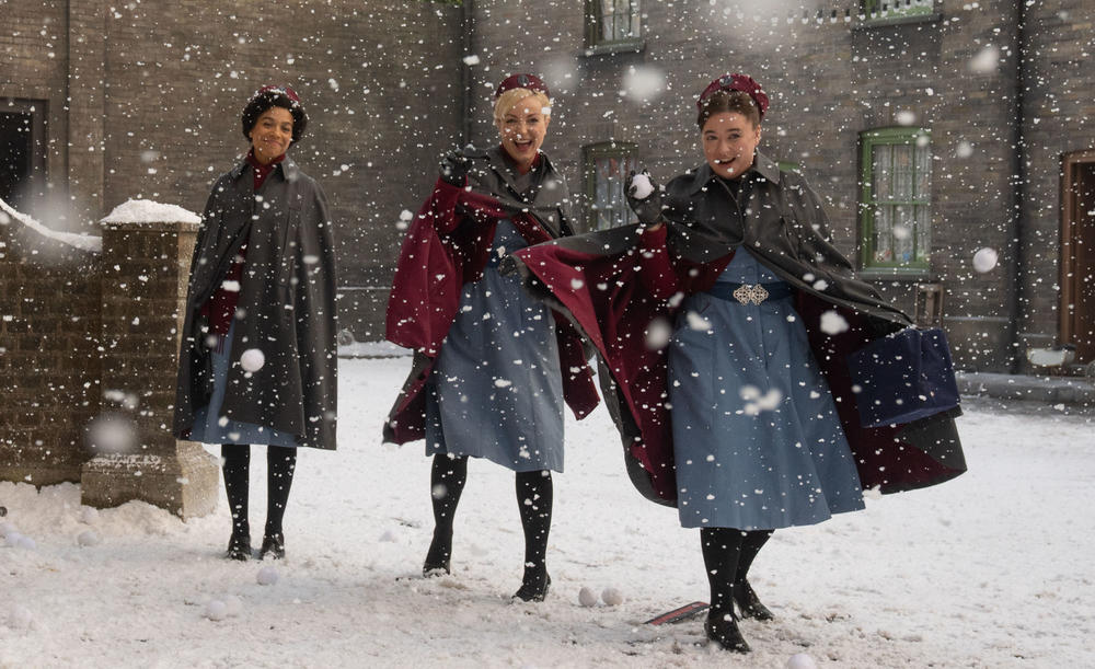 The cast of Call the Midwife on a snowy set.