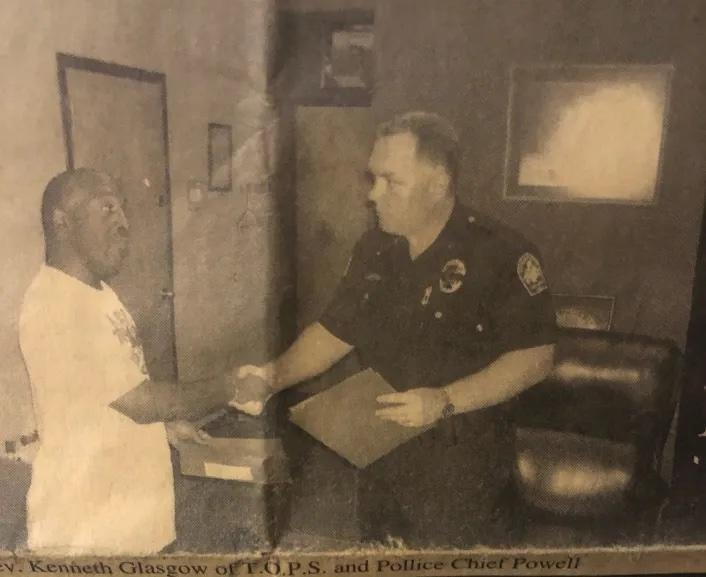 A picture of Rev. Kenneth Glasgow shaking hands with then-Dothan Police Chief John Powell, captured in an October 2006 edition of a defunct Black newspaper in Alabama, according to Glasgow.  Credit: Kenneth Glasgow