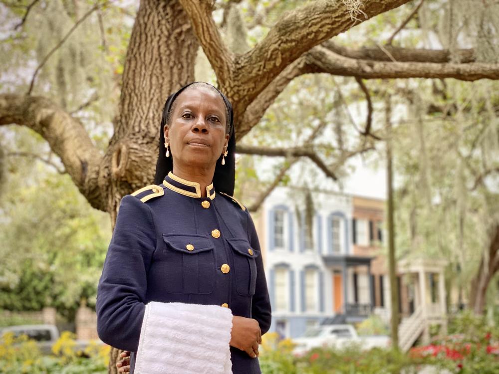 Rozz Rouse, who co-chairs the Coalition to Name Taylor Square, poses at the Savannah square formerly named Calhoun Square. She is dressed as Susie King Taylor, a nurse who served with the Union during the Civil War.