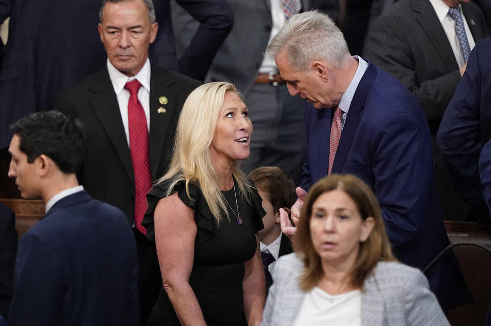 Rep. Marjorie Taylor Greene, R-Ga., talks with Rep. Kevin McCarthy, R-Calif., during the vote for House Speaker on the opening day of the 118th Congress at the U.S. Capitol, Tuesday, Jan. 3, 2023, in Washington. Alex Brandon/AP