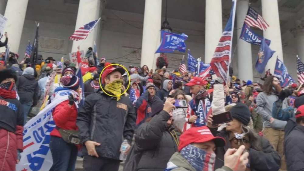 In this photo provided by the FBI, the man in the yellow circle is identified by an agent as Dominic Box on the east stairs of the U.S. Capitol on Jan. 6, 2021.