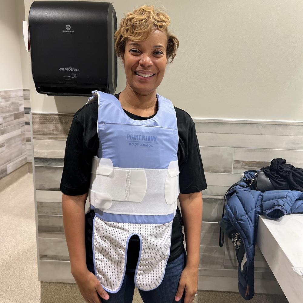 Woman in bulletproof vest.