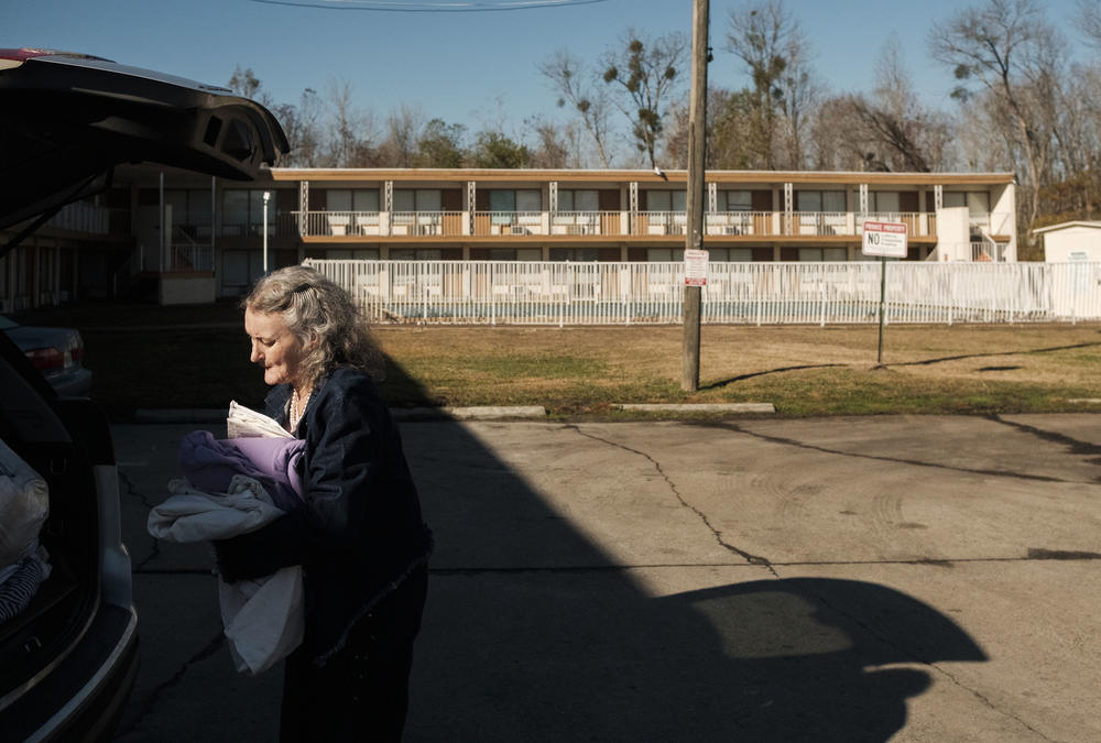 June O'Neal bundles up blankets for Keisha Gibson's family. O'Neal is a long time advocate for youth in Macon who spends most of her days delivering provisions to families.