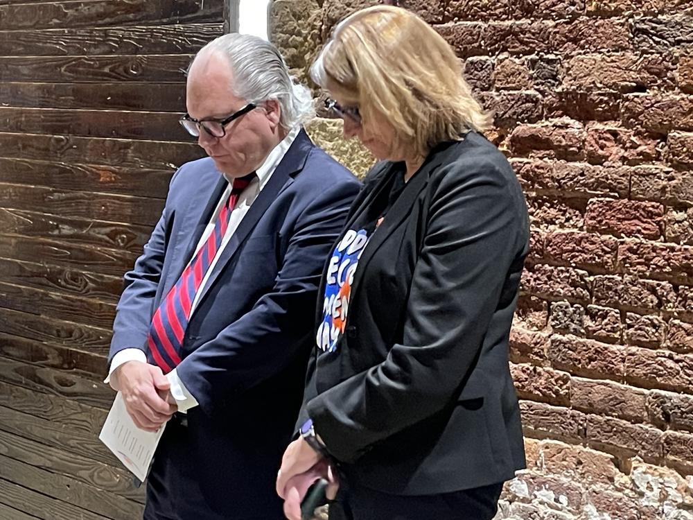 Jeff Breedlove and Neil Campbell bow their heads in a moment of silence during the Georgia Addiction Recovery Awareness Day Jan. 24, 2023