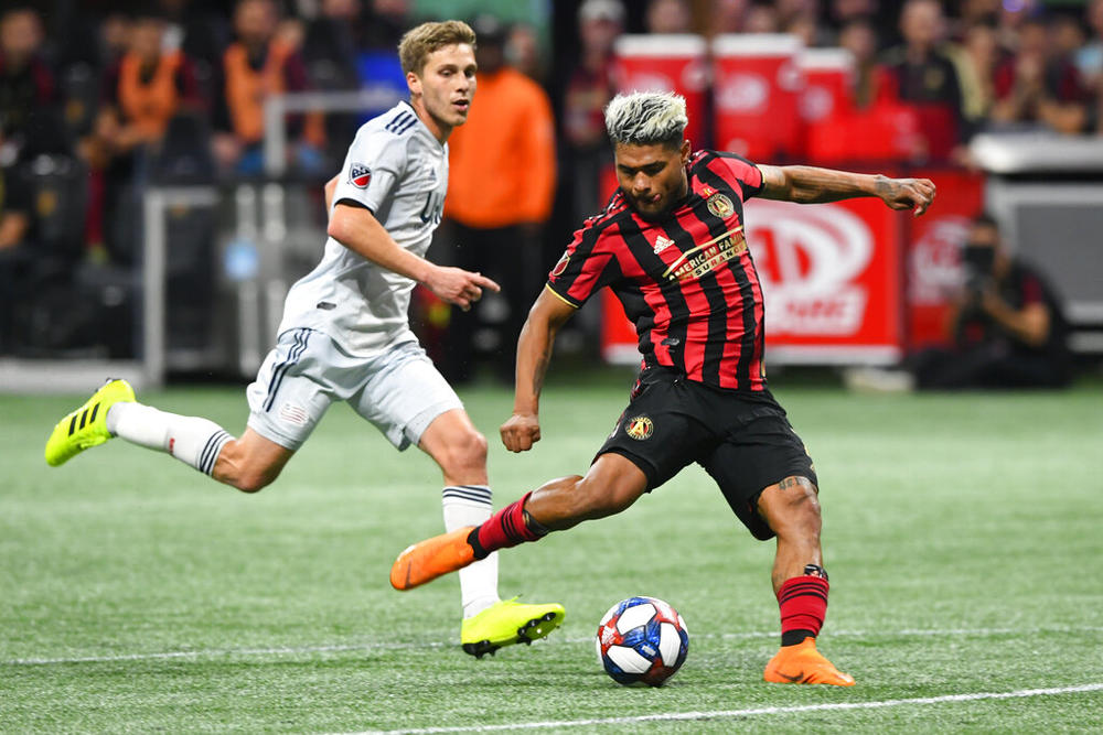 Atlanta United forward Josef Martinez (7) kicks a shot on goal as New England Revolution midfielder Scott Caldwell follows during round one of an MLS Cup playoff soccer game Saturday, Oct. 19, 2019, in Atlanta. Josef Martinez, the 2018 MVP and centerpiece of Atlanta United's rise to prominence in Major League Soccer, was released by the team on Wednesday, Jan. 18, 2023, and quickly signed a deal with Inter Miami.