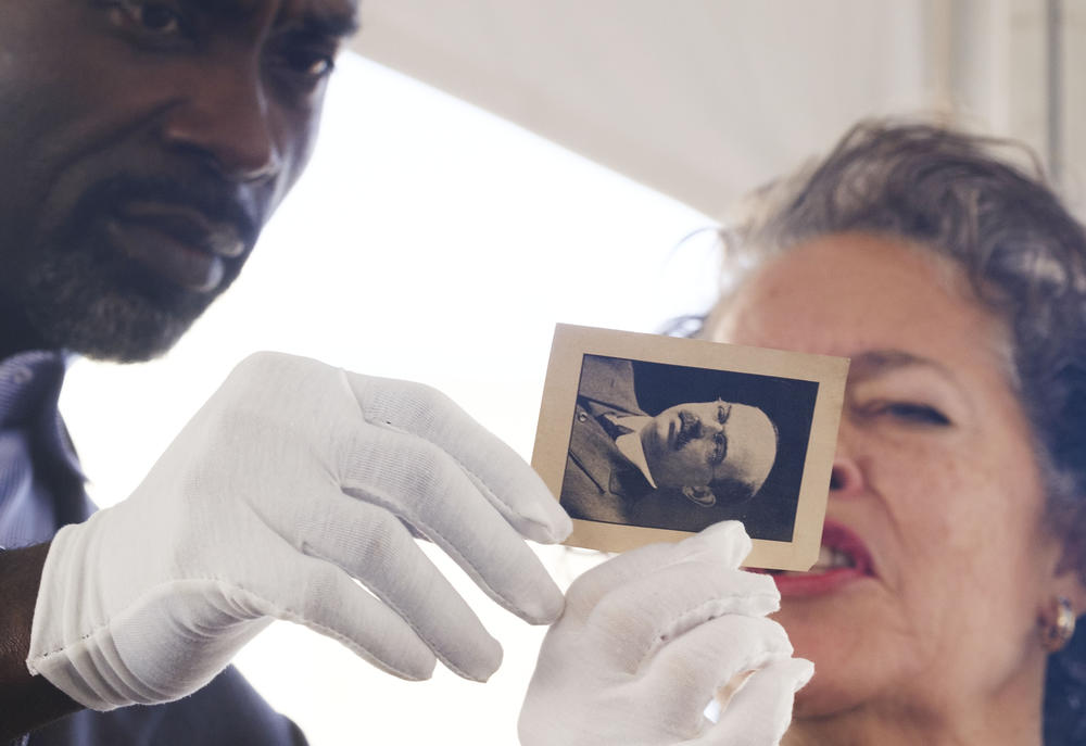 Atrium Navicent CEO Delvecchio Finley, left, and board member Starr Purdue with a photo from the 1916 time capsule, historic significance unknown. 