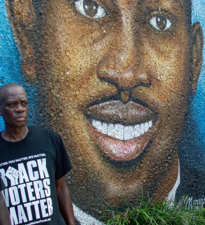 Ahmaud Arbery’s uncle stands in front of his nephew’s mural. Credit: Jeffery M. Glover/ The Current GA