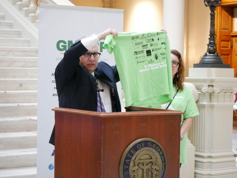 Jeff Breedlove with the Georgia Council for Recovery holds up the t-shirt honoring the late Speaker David Ralston. Jill Nolin/Georgia Recovery