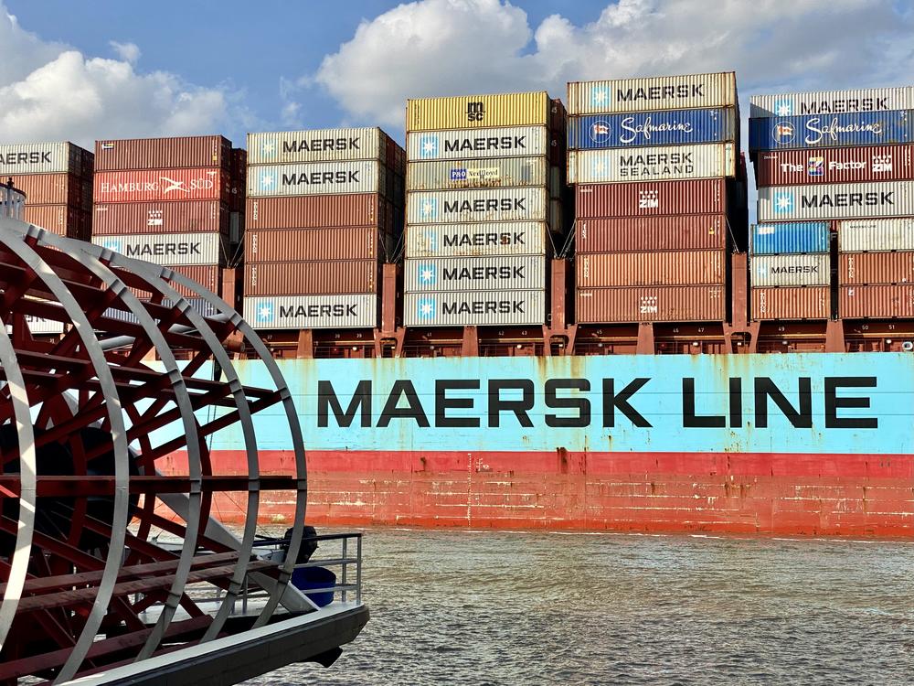 The container ship Adrian Maersk sails past the riverboat Georgia Queen on the Savannah River.