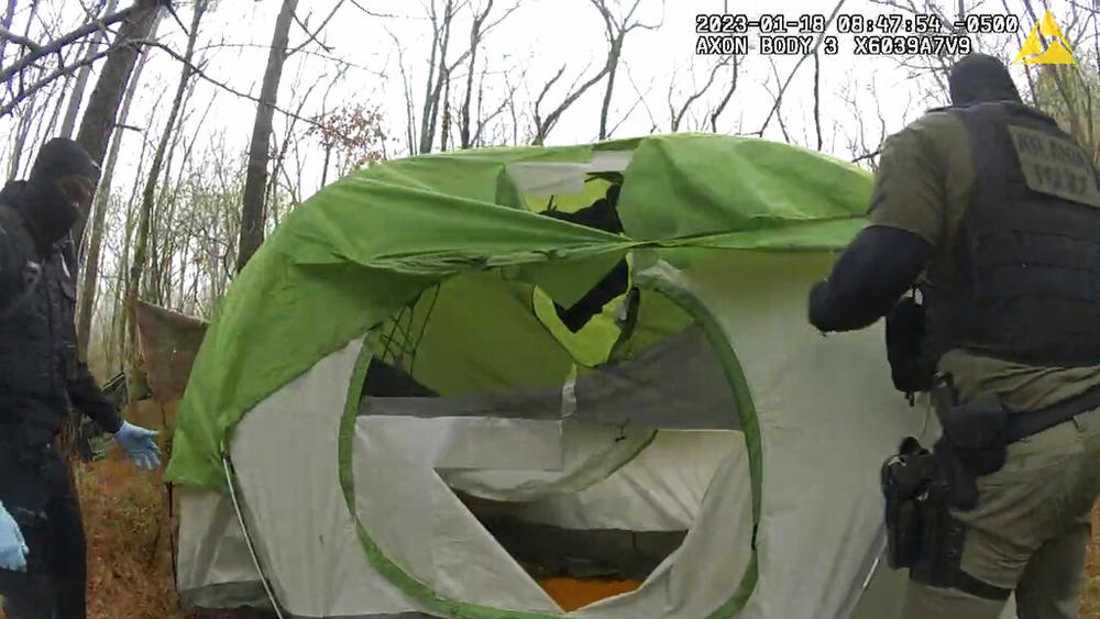 In this image taken from body cam video released by the Atlanta Police Department, officers remove and shred items from empty tent near the future site of the City of Atlanta’s Public Safety Training Center on Jan. 18, 2023, near Atlanta, Ga. Some activists — self-described “forest defenders” — began moving into the forest in protest. 