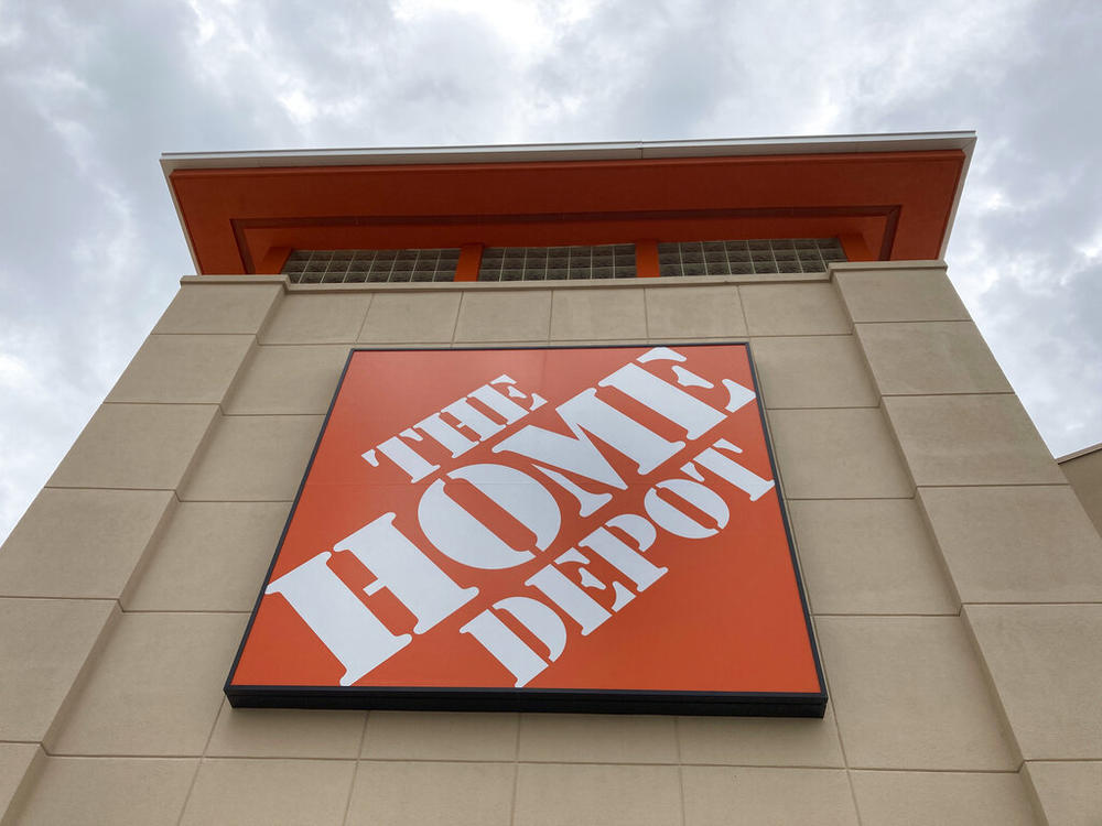A Home Depot logo sign hands on its facade, Friday, May 14, 2021, in North Miami, Fla. Home Depot reports their financial earnings on Tuesday, Feb. 21, 2023.