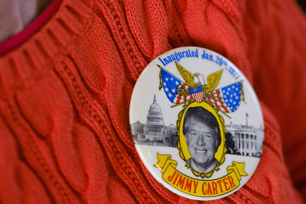 Rebecca Davenport of Columbus wears her vintage 1977 election pin at the Jimmy Carter National Historic Site in Plains, Ga. on Monday.