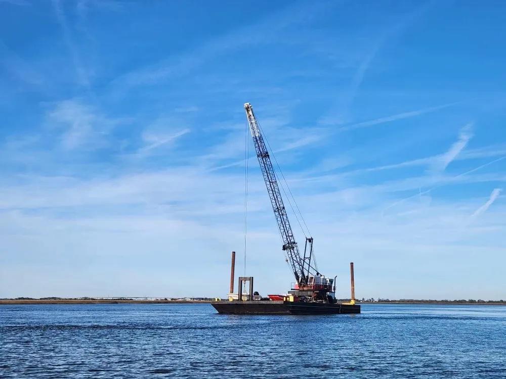 Myrick Marine positioned a barge off Twin Palms to haul debris off the island. The cleanup will cost taxpayers $35,000, Credit: Georgia DNR