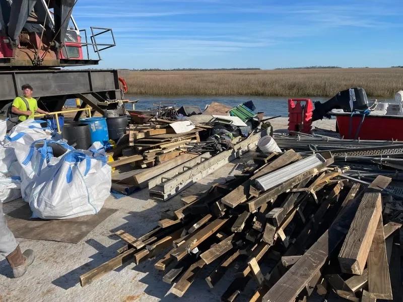 A barge is loaded with dismantled structures removed from Twin Palms, and the work isn’t finished. Credit: Georgia DNR