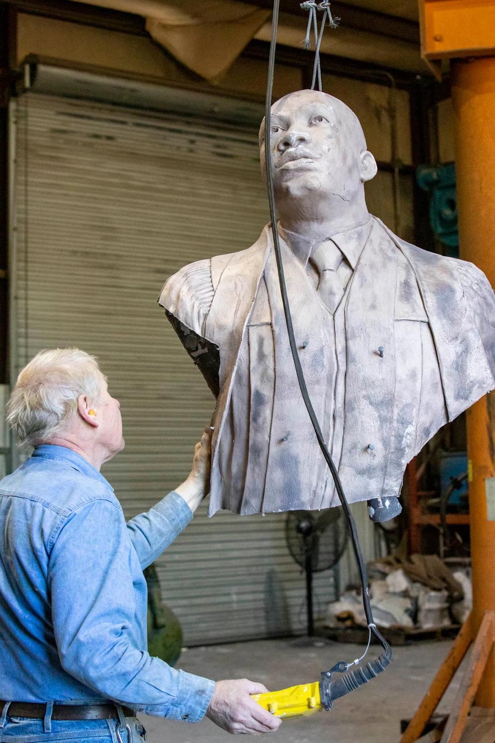 Metal fabricator Dale Smith with the bust of Dr. King. 