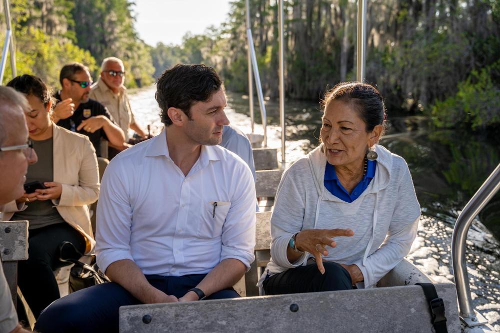 Sen. Jon Ossoff speaks with U.S. Interior Secretary Deb Haaland during a tour of the Okefenokee National Wildlife Refuge in September 2022.