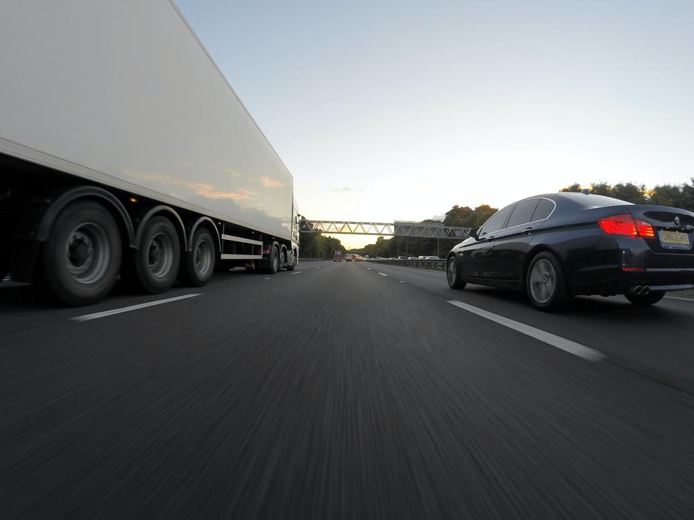 Highway with truck and car in opposite lanes