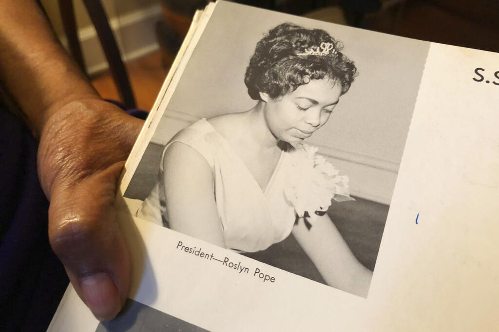 In this March 4, 2020 photo, Roslyn Pope shows her Spelman College yearbook at her home in Atlanta. Roslyn Pope, a college professor and musician who wrote “An Appeal for Human Rights,” laying out the reasons for the Atlanta Student Movement against systemic racism in 1960, has died. She was 84. Pope died on Jan. 18 in Arlington, Texas, where she moved from Atlanta to be with her daughters after her health began to fail in 2021, according to her family's obituary. 