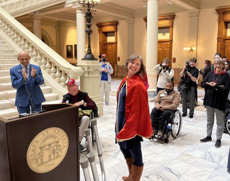Sen. Sally Harrell wears a superhero cape, which she said was a gift from an advocate. “This is what it’s going to take as we go forward,” she said Thursday. Jill Nolin/Georgia Recorder