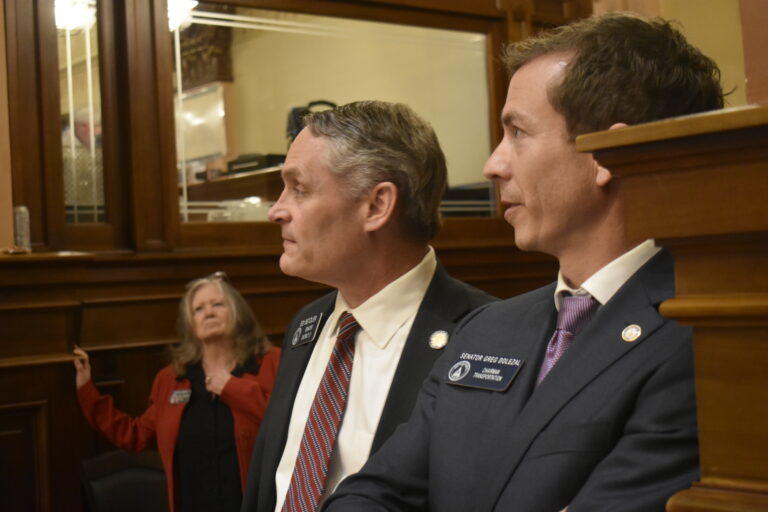 Voucher supporters Sen. Greg Dolezal (right) and Sen. Ed Setzler (center) watch the House vote come in. Ross Williams/Georgia Recorder