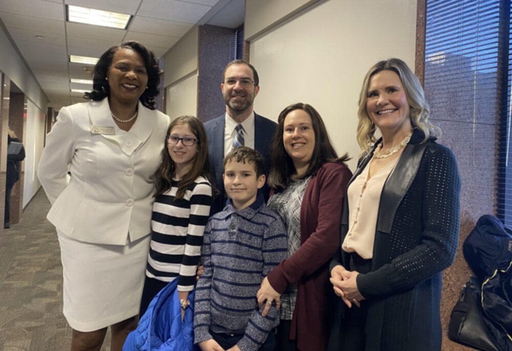 The Genauers, state Rep. Debra Bazemore D-South Fulton and state Sen. Elena Parent (D-Dekalb) smile on Monday, March 13, 2023, after the Small Business Development House committee unanimously cleared Senate Bill 55.