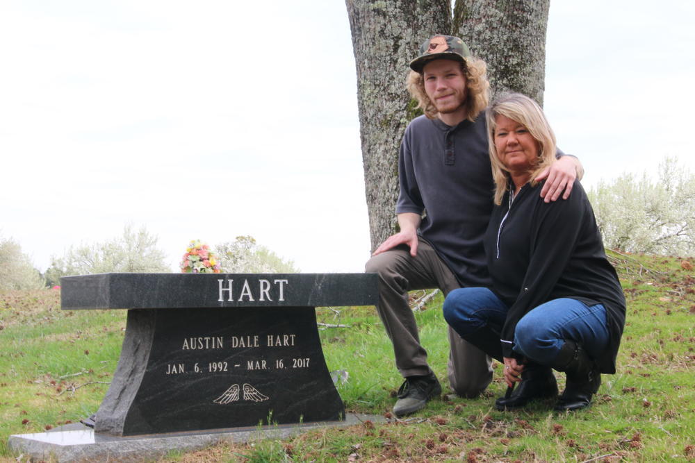 Preston Wysocki (left) and mother Heather Wysocki visit the grave of Austin Hart and Dustin Hart on Saturday, March 14, 2020.