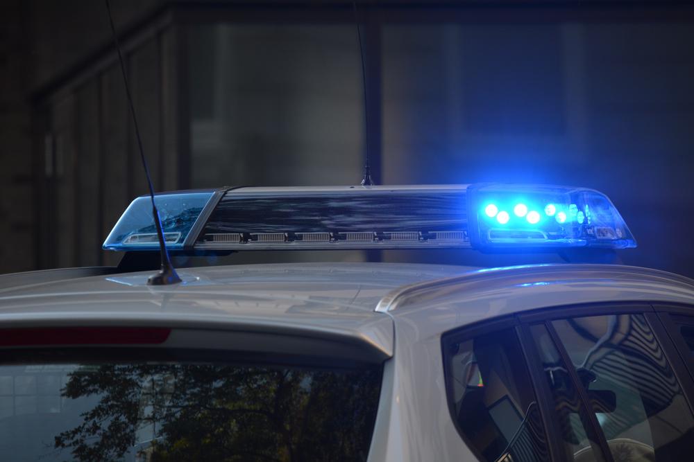 police lights flashing on top of a police car