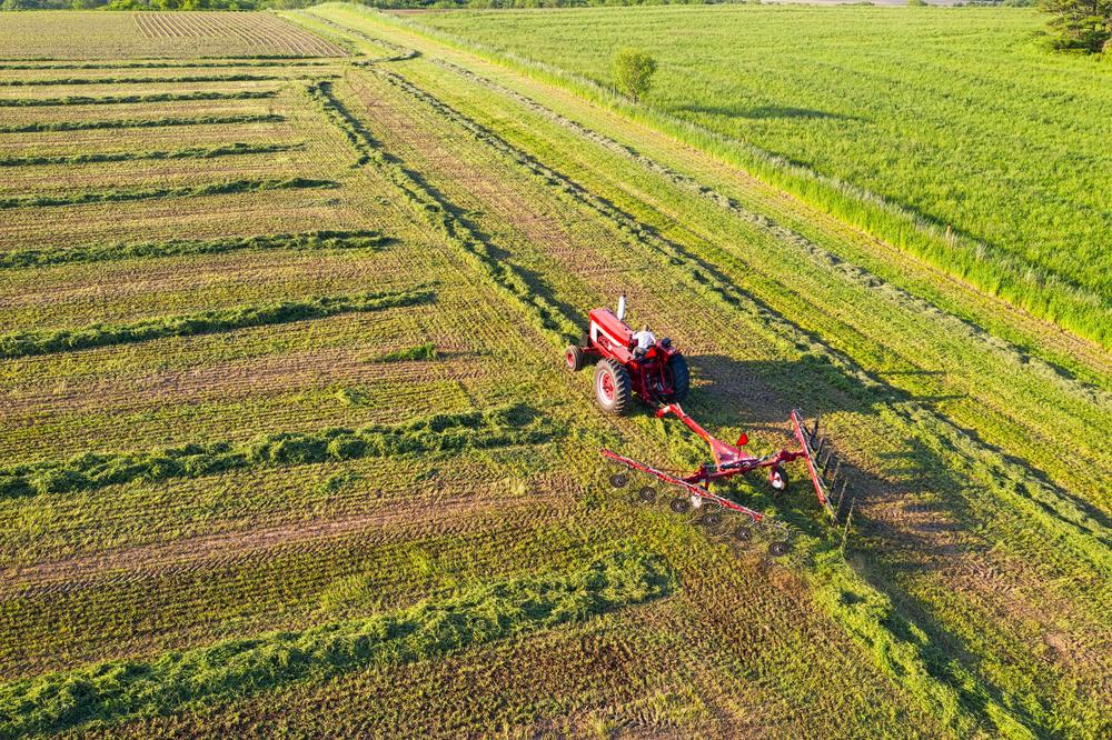 High angle view of a red tractor in a green field