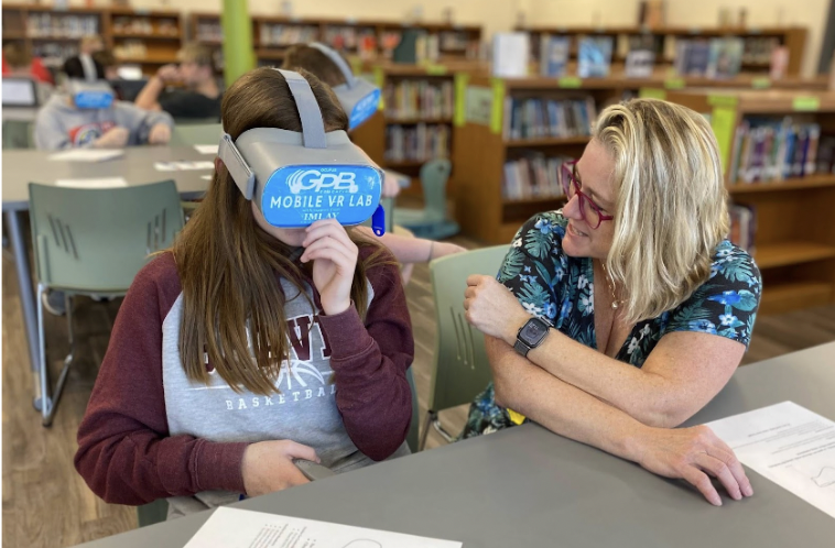 Bethanie Boswell with a student in VR headset