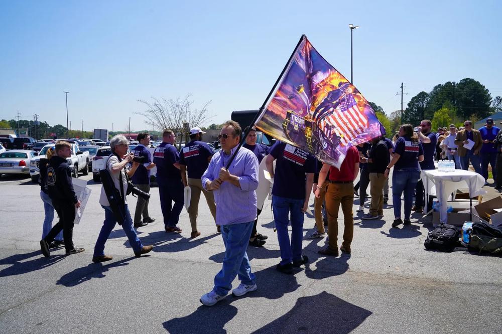 Trump supporters wave flags at a March 2023 Ron DeSantis book signing event