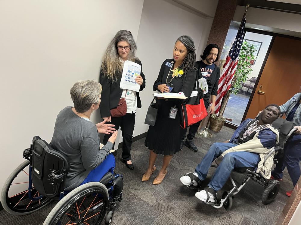 Wendy Dean (left) with the Georgia Advocacy Office talks to state Sen. Nikki Merritt in the hallway of the Coverdell Legislative Office Building on Wednesday’s day of advocacy. Jill Nolin/Georgia Recorder