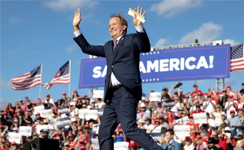 Texas Attorney General Ken Paxton waves to the crowd during a rally featuring former President Donald Trump on Oct. 22, 2022, in Robstown, Texas.