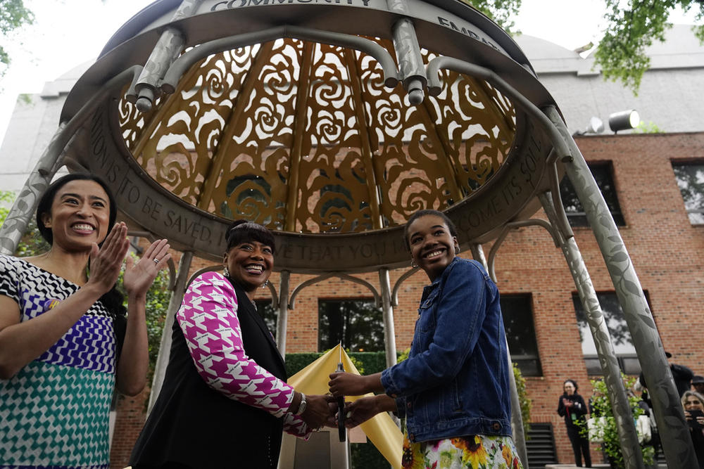 The Rev. Bernice King, center, daughter of the Rev. Martin Luther King Jr. and Coretta Scott King, granddaughter of Rev. Martin Luther King Jr., Yolanda Renee King, right, and artist Saya Woolfalk, left, attend during the dedication of the Coretta Scott King Peace and Meditation Garden and monument on Thursday, April 27, 2023, in Atlanta.