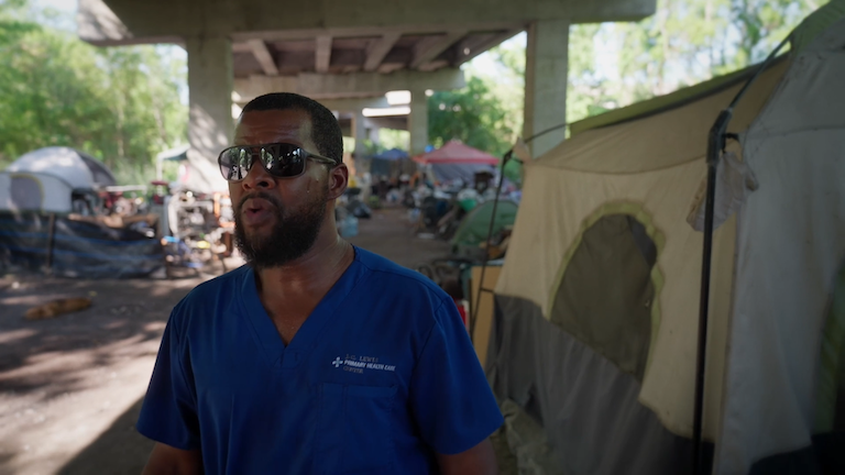 A medical worker in an encampment.