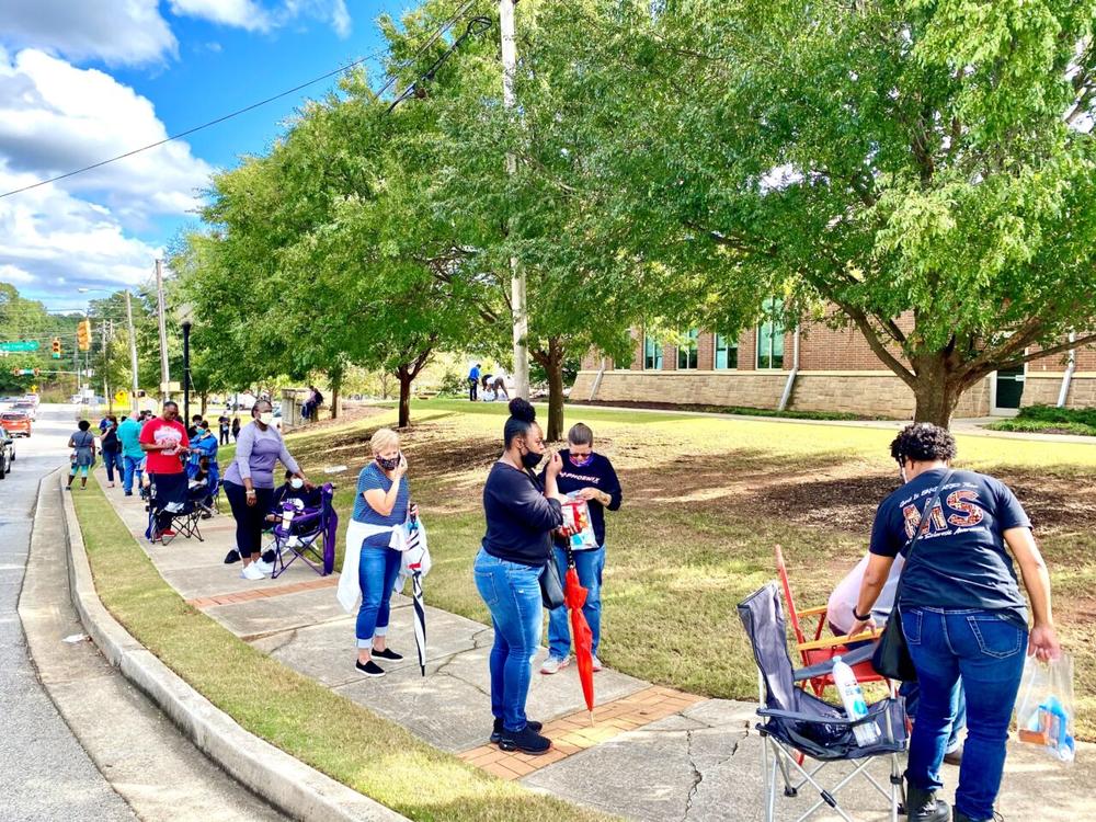 Voters wait in line outside a polling place. 