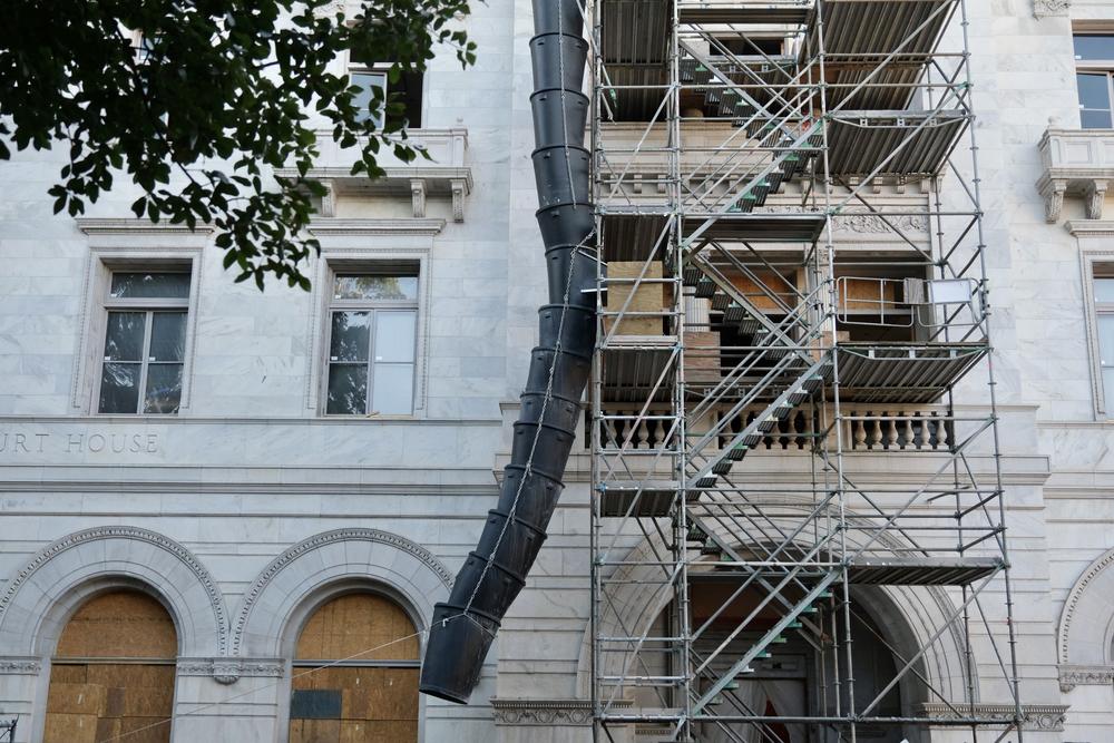 A construction debris chute is seen outside the courthouse on April 17, 2023.