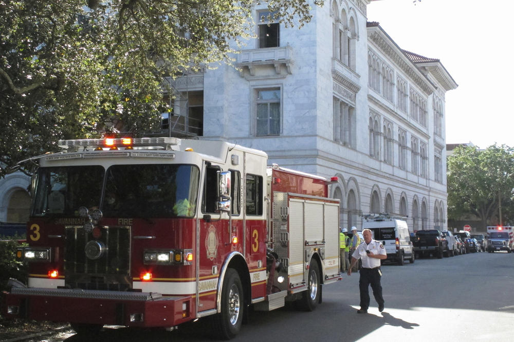 A firetruck sits outside the historic federal courthouse on Tuesday, April 11, 2023, in Savannah, Ga., after part of an upper floor collapsed and injured three construction workers. The U.S. government building, which dates to 1899, has been undergoing extensive renovations for more than a year. 