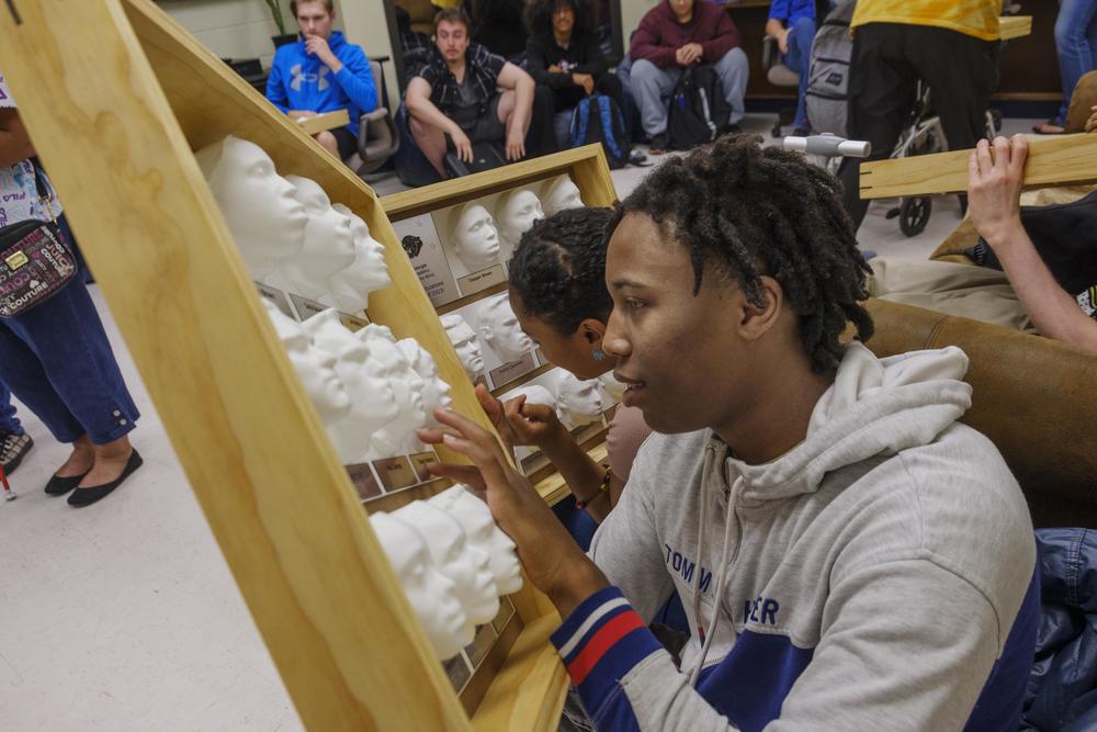 Georgia Academy for the Blind senior Daquan Brown with the 3D yearbook printed for him and other members of the Class of 2023 by Mercer University engineering students.