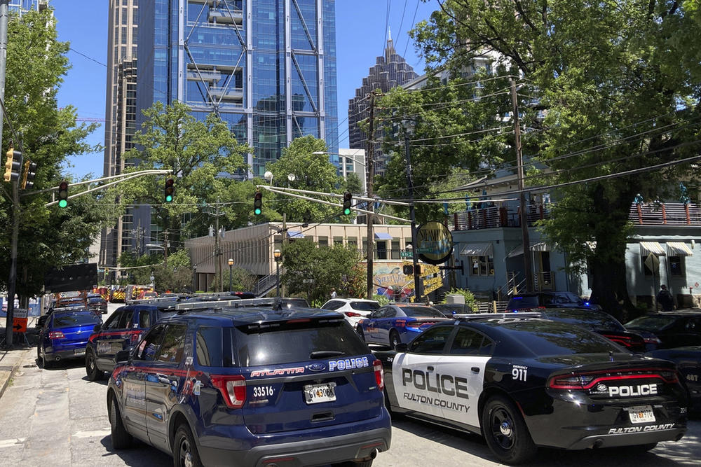 Emergency vehicles arrive on West Peachtree in Atlanta on Wednesday, May 3, 2023. Police say are investigating an “active shooter situation” in a building in Atlanta's Midtown neighborhood and that multiple people had been injured.