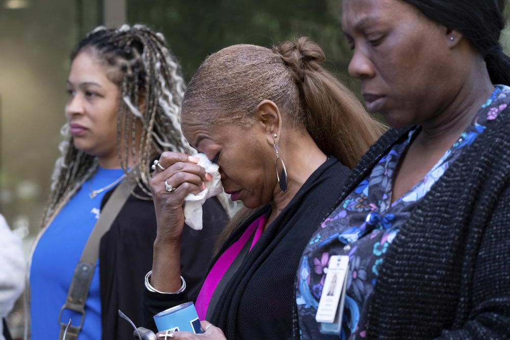 A woman tears up after evacuating following a shooting at a medical building in Midtown Atlanta on Wednesday, May 3, 2023. 