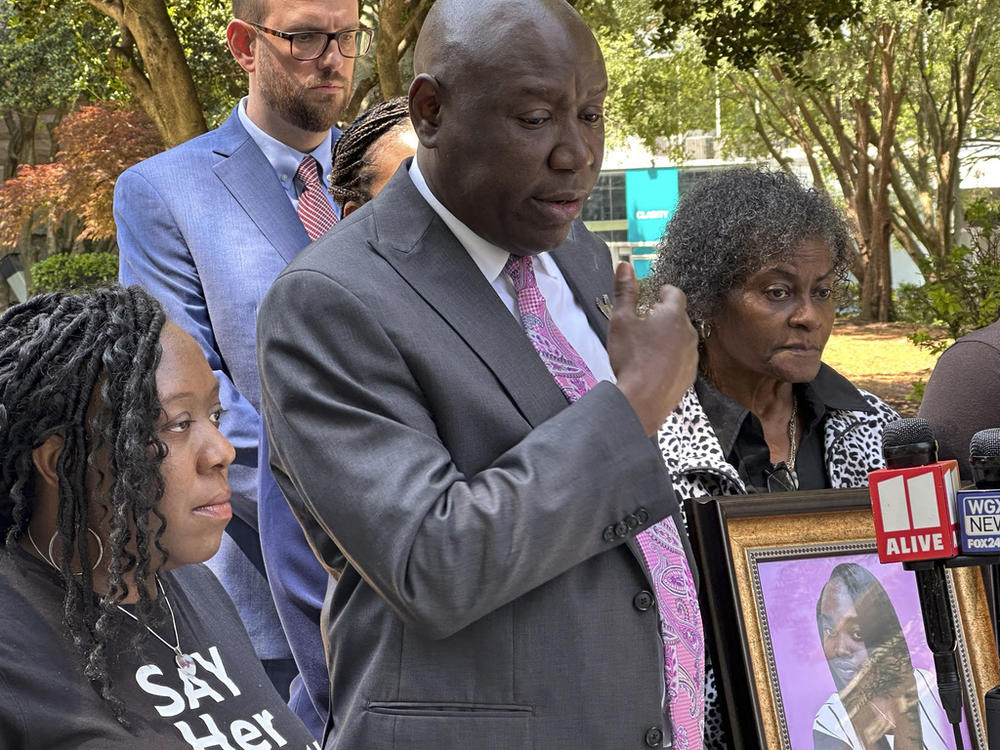 Prominent civil rights attorney Ben Crump speaks at a news conference on Wednesday, May 24, 2023, in Decatur, Ga., announcing a wrongful death lawsuit filed by the family of a Georgia woman who died after she fell out of a moving patrol car in July 2022, following her arrest. Crump was joined in front of the old courthouse in Decatur, by Brianna Grier's sister Lottie Grier, left, and mother Mary Grier, right. 