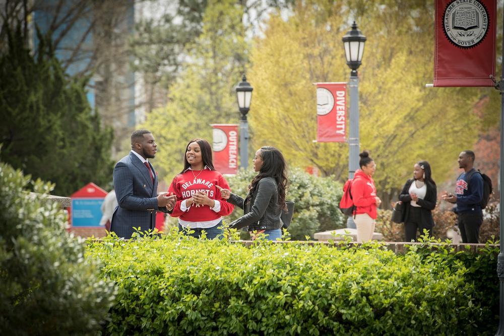 Students talking on campus outside at Delaware State University