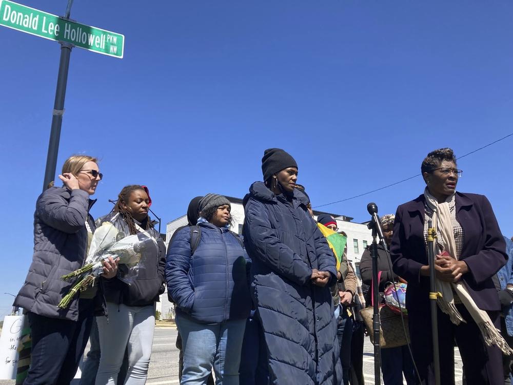 Valerie Handy-Carey stands with family members and city leaders on Donald Lee Hollowell Parkway on March 19, 2023, in Atlanta. Several months earlier, her daughter, Brittany Glover, was hit by a car and died while trying to cross the intersection. With pedestrian deaths in the U.S. at their highest in four decades, citizens across the nation are urging lawmakers to break from transportation spending focused on car culture. Atlanta, she said, needs to do more to protect pedestrians and cyclists.