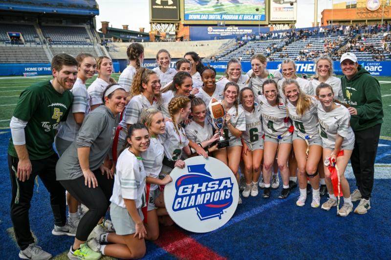 Coach Brandon Harwell (far right) and the Blessed Trinity Titans celebrate after winning the program’s first ever state title.