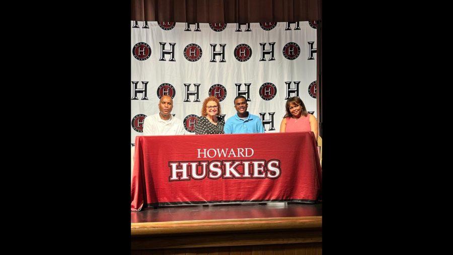 Chase, center, is pictured with his parents, Charles and Felisha Kitchens, and Bibb County school board member Lisa Garrett.