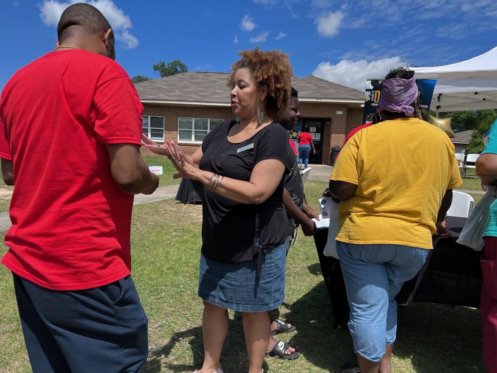 Alysia Cutting, rural health equity director with SOWEGA Rising, talks to people about the Medicaid unwinding process during a recent health fair in Albany. 