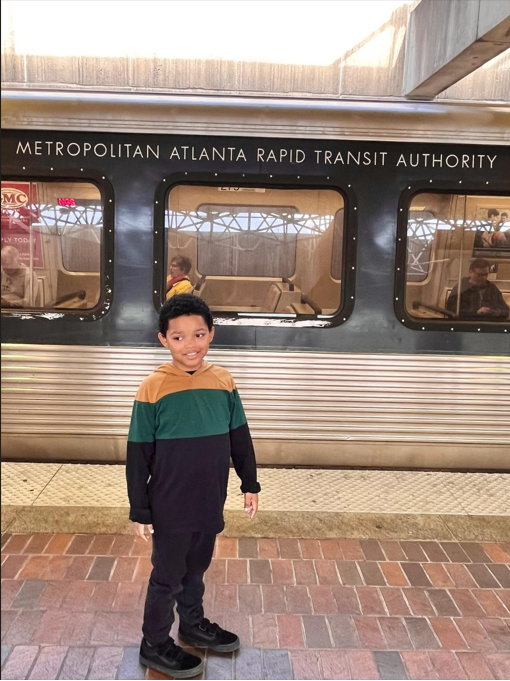 Immanuel Stephens stands in front of a MARTA train